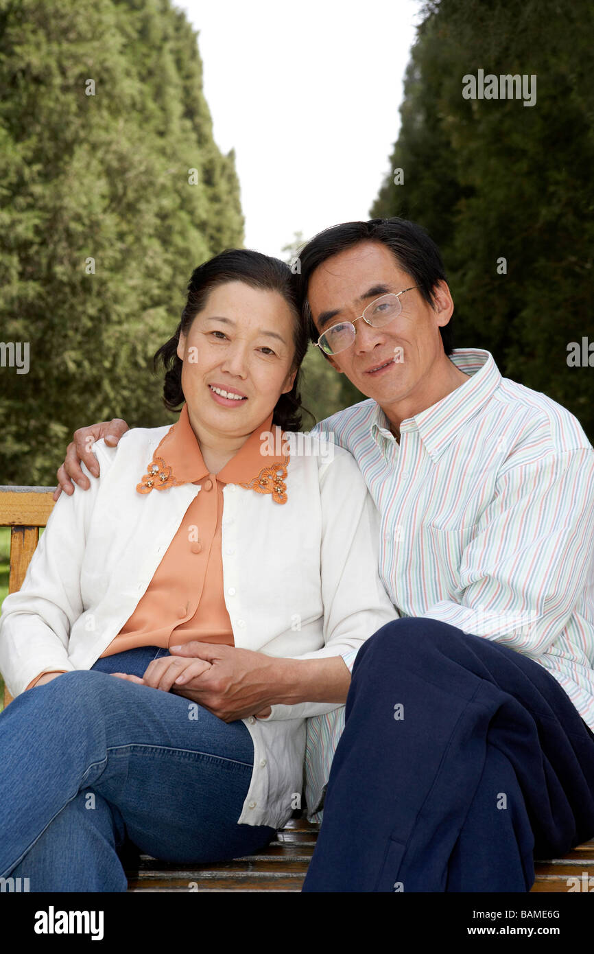 Senior Couple Sitting On Park Bench Together Stock Photo - Alamy
