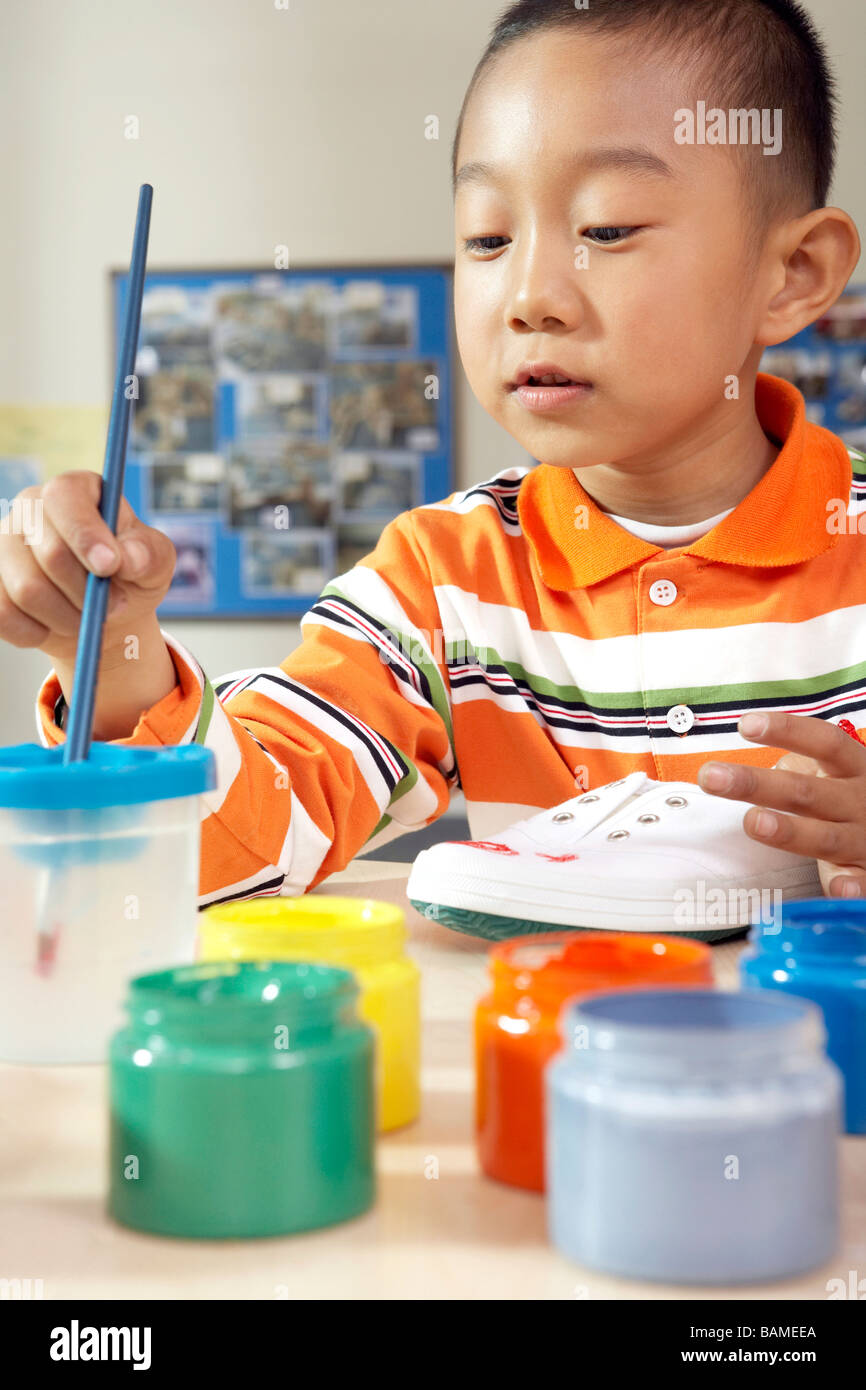 Boy Painting Shoe Stock Photo Alamy
