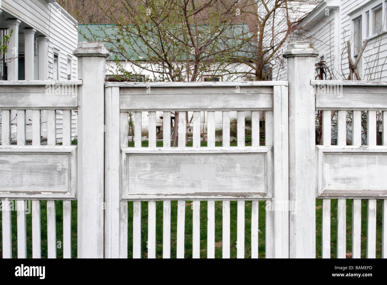 White fencing around a garden yard Stock Photo