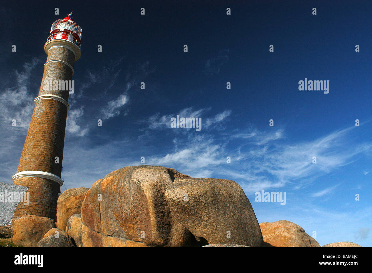 Polonium lighthouse cape and a blue sky with clouds and a nice big rock Stock Photo