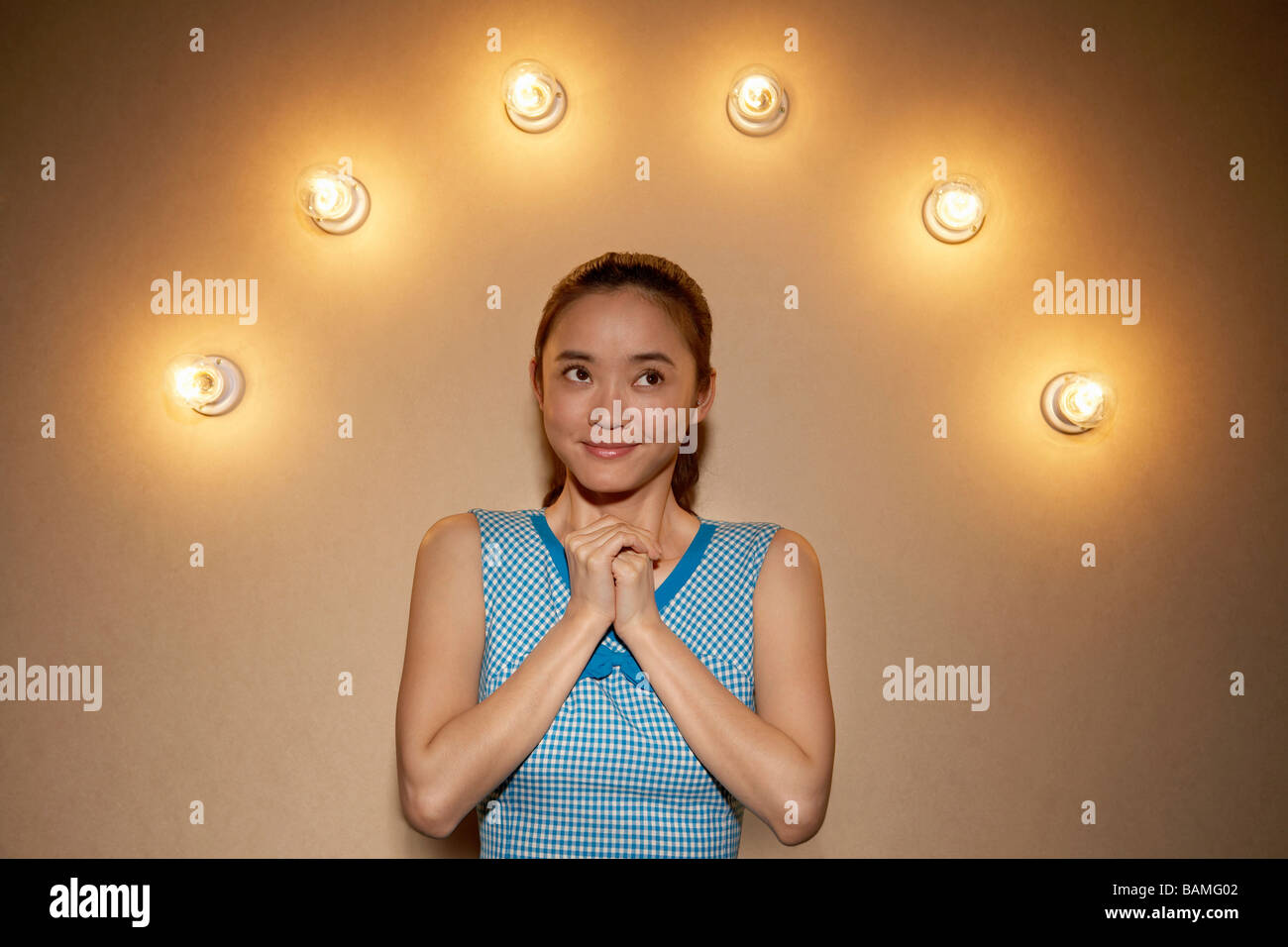 Young Woman With A Halo Of Lightbulbs Stock Photo
