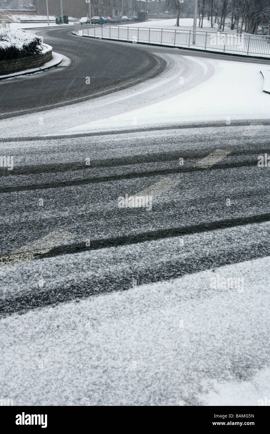 Empty roads with tyre tracks in the snow Stock Photo - Alamy