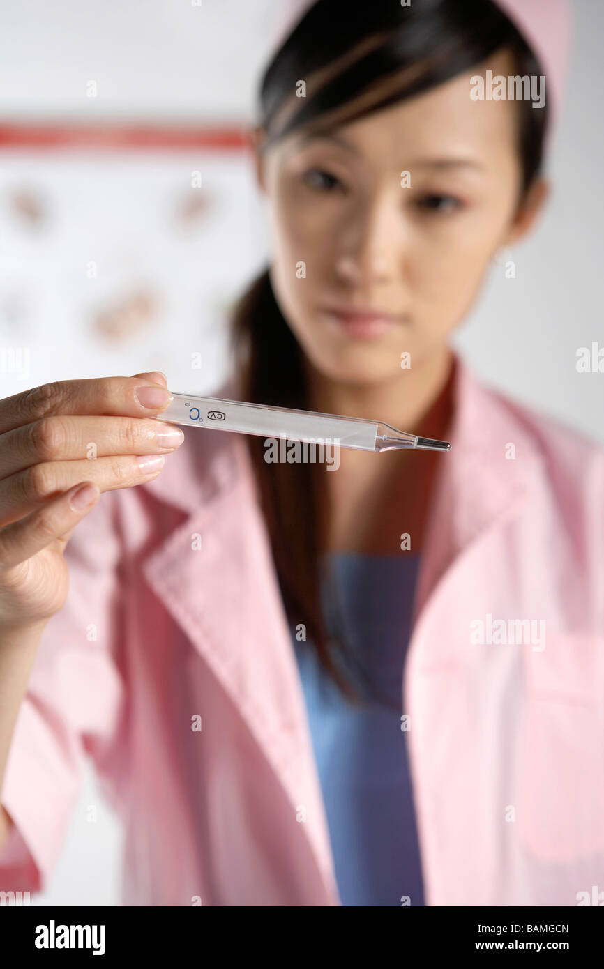 Nurse Holding A Thermometer Stock Photo Alamy