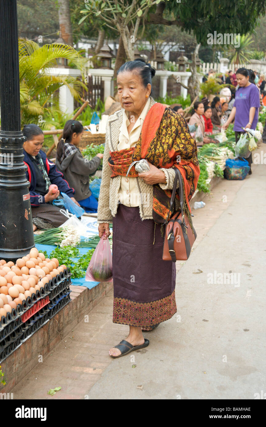 Old woman out shopping in the food market Luang Prabang Laos Stock Photo