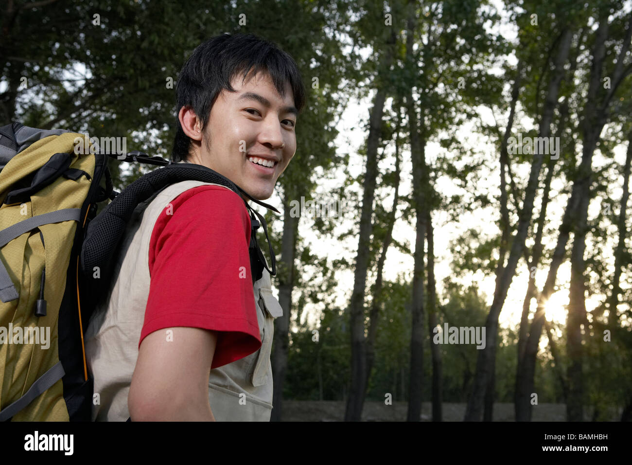 Young man walking backpack hi-res stock photography and images - Alamy