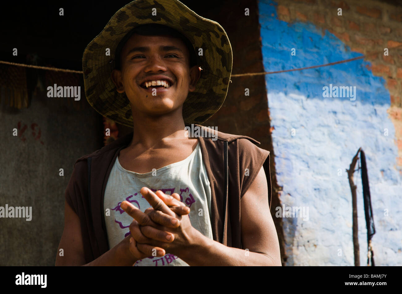 young smiling nepali man infront of his home Stock Photo