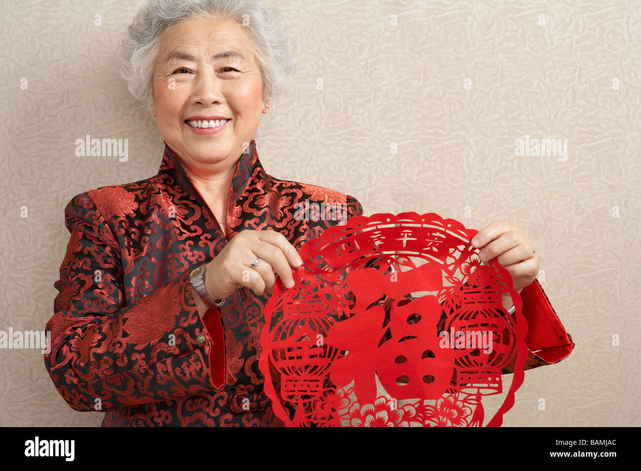Women Holding Paper Cutting Which Symbolizes Luck Stock Photo
