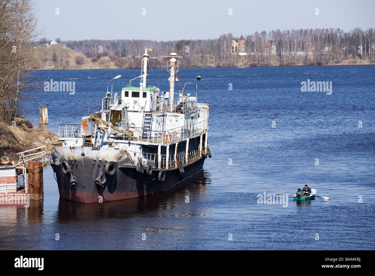 small ship anchoring near coast moorage Stock Photo
