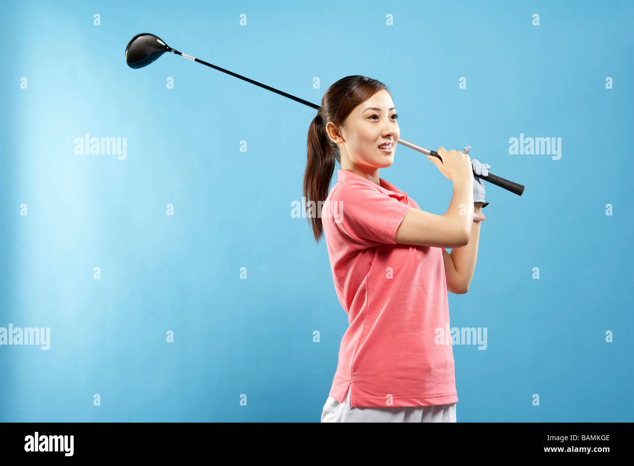 Woman Swinging Golf Club Stock Photo Alamy