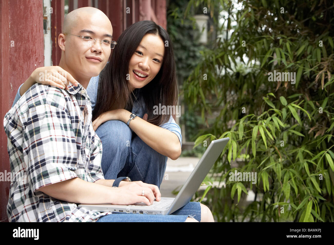 Young Couple Looking At Laptop Computer Stock Photo - Alamy