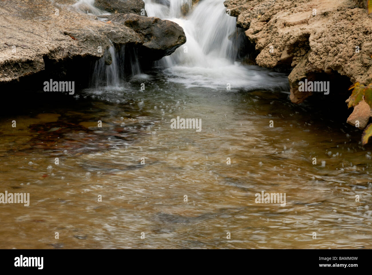 Water flows through rock, carving out interesting shapes at Turner Falls Park near Davis, Oklahoma, USA. Stock Photo