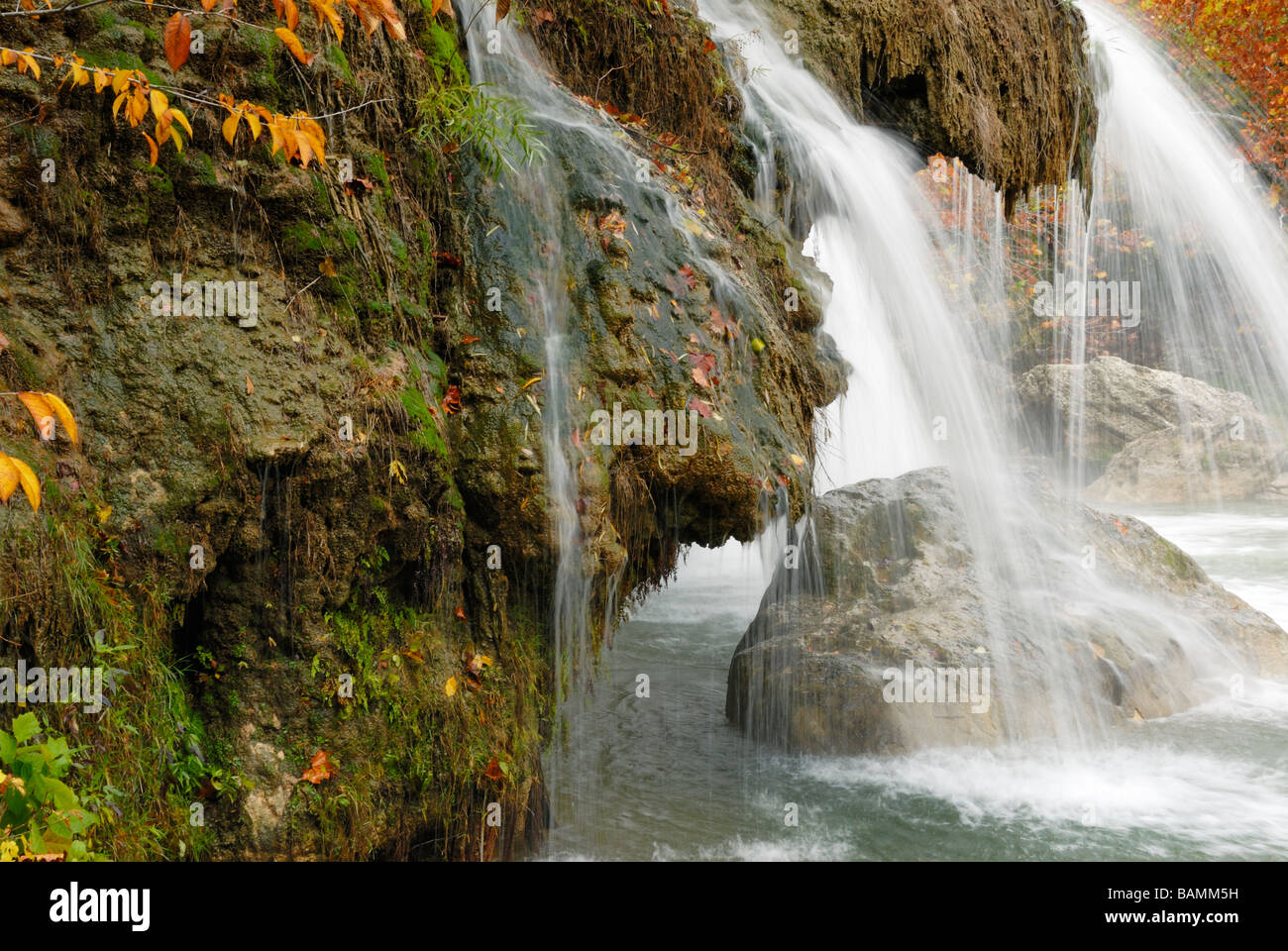 A 77-foot waterfall flows over mossy rocks at Turner Falls Park near Davis, Oklahoma. USA. Stock Photo