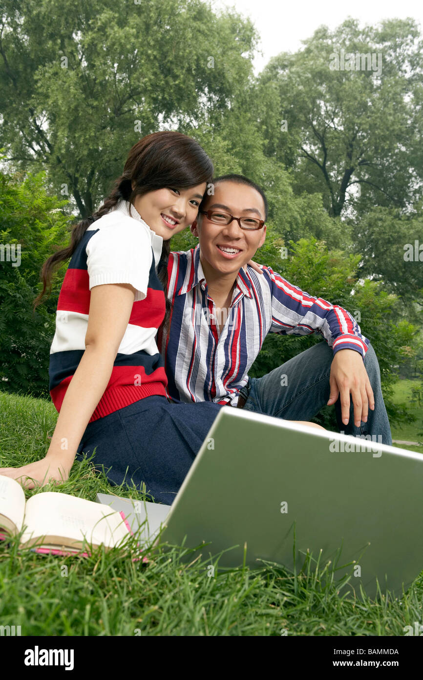 Portrait Of Young Couple In The Park Stock Photo - Alamy