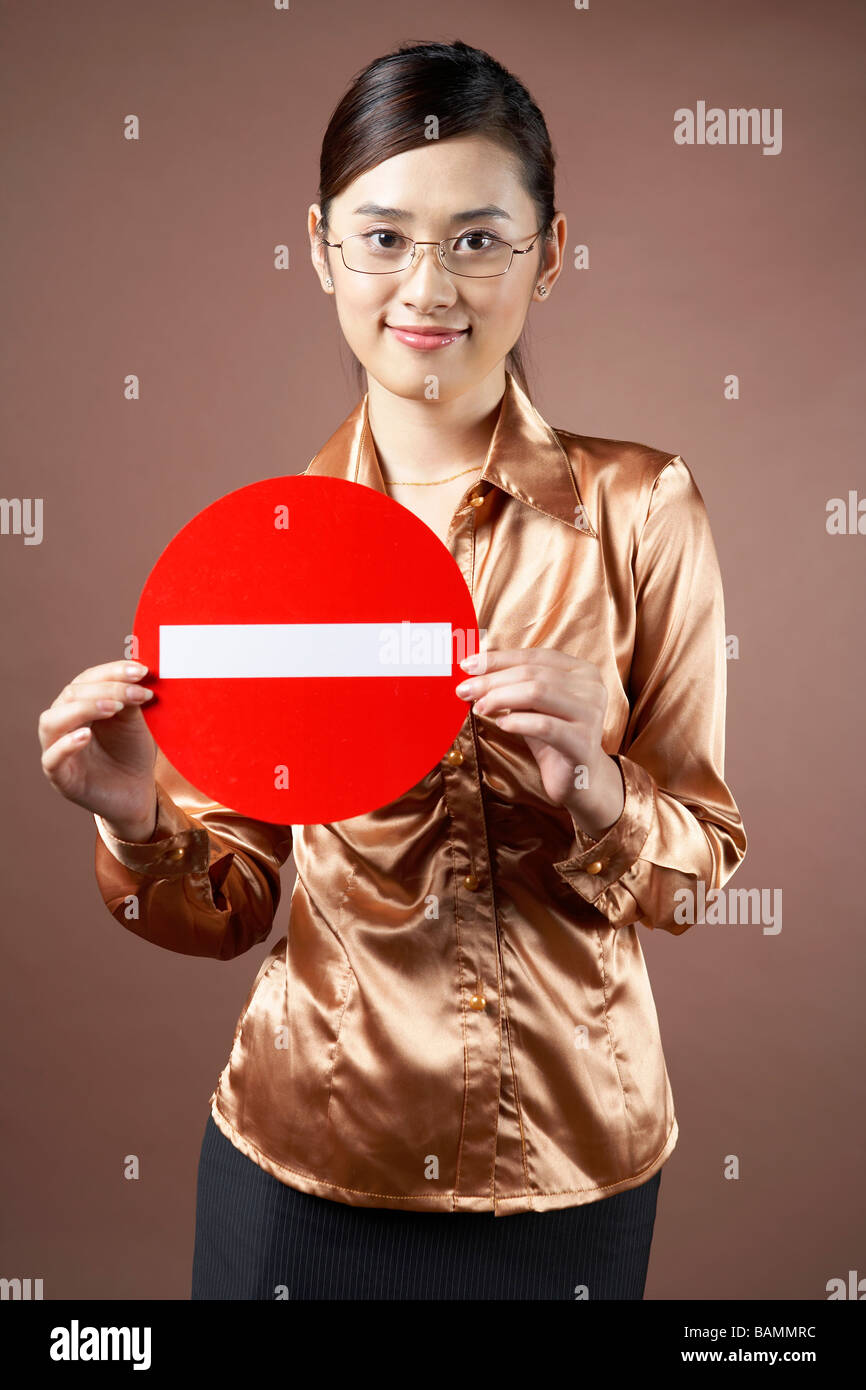 Young Woman Holding A Road Sign Stock Photo - Alamy