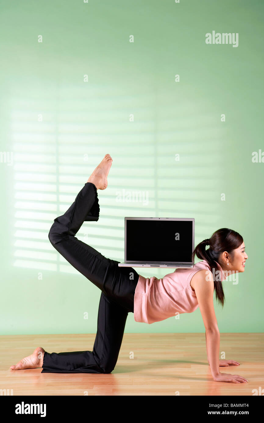 Woman Balancing Laptop Computer On Her Back Stock Photo - Alamy