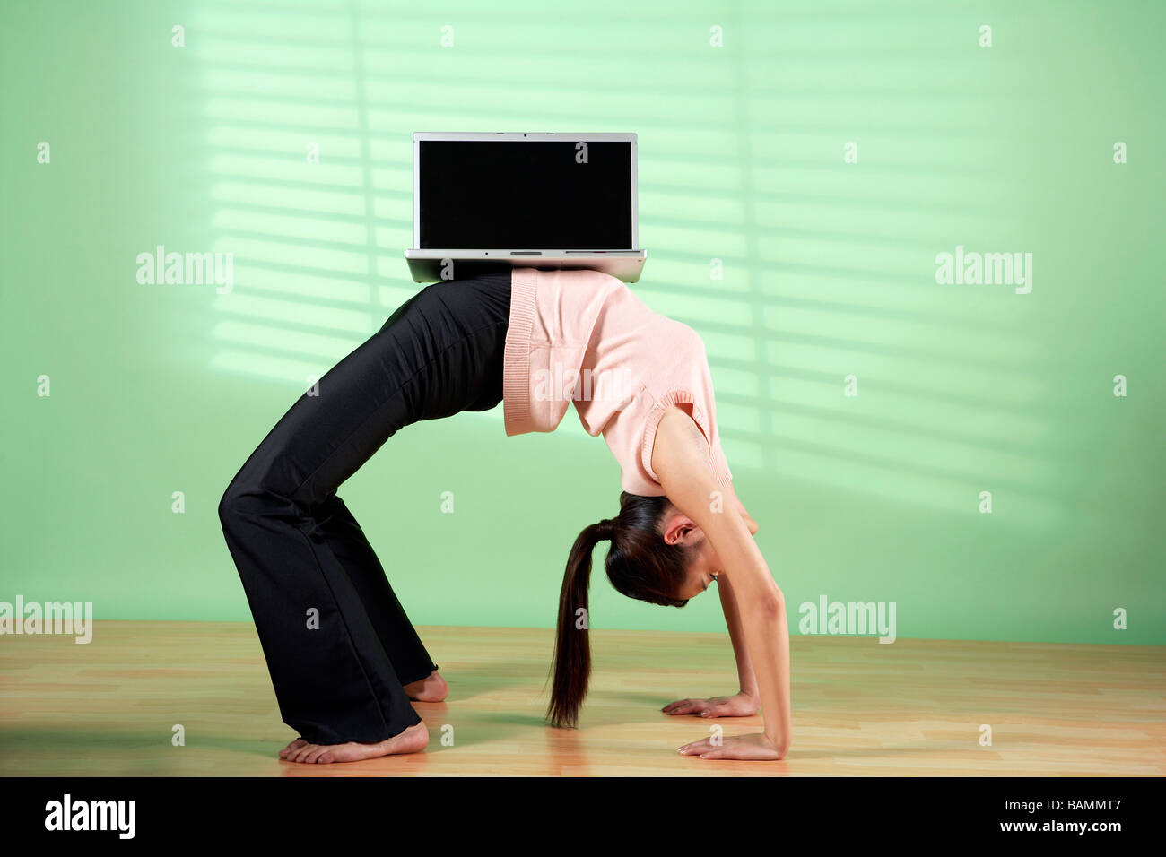 Woman Balancing Laptop Computer On Her Stomach Stock Photo Alamy