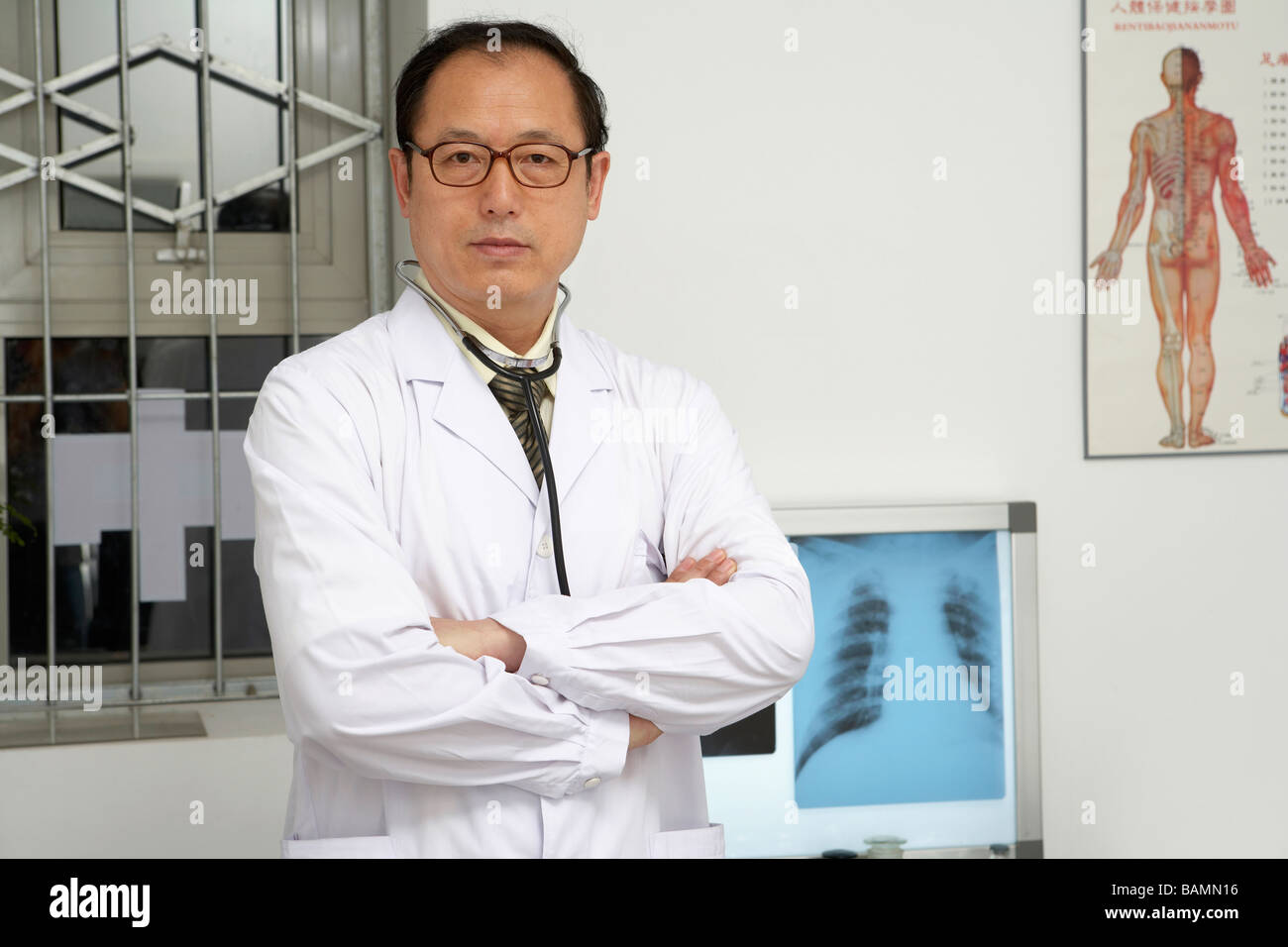 Serious doctor folded arms hi-res stock photography and images - Alamy