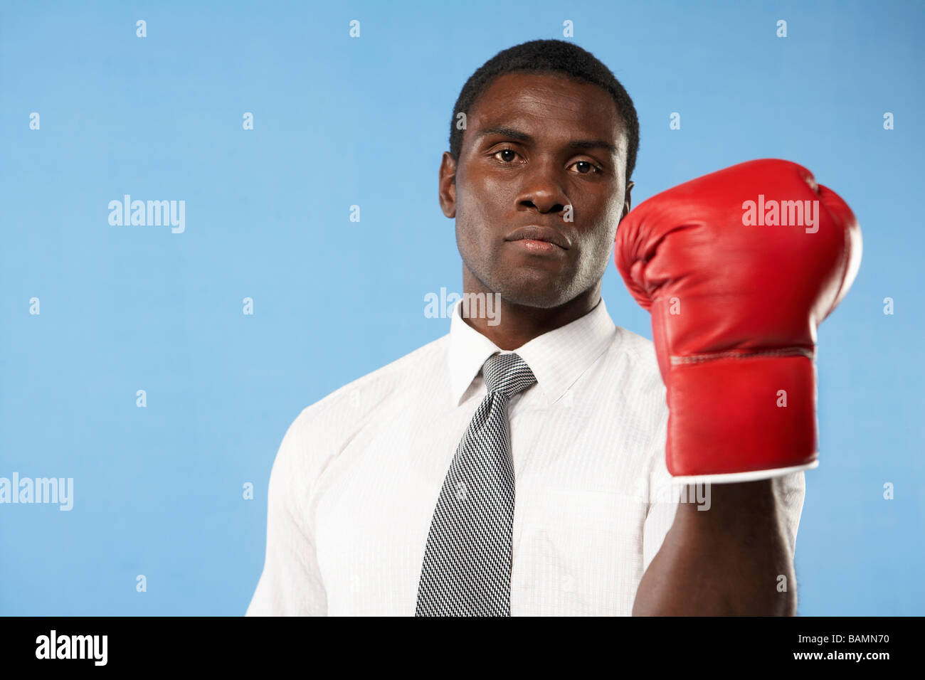 Businessman Wearing Boxing Glove With Raised Fist Stock Photo Alamy