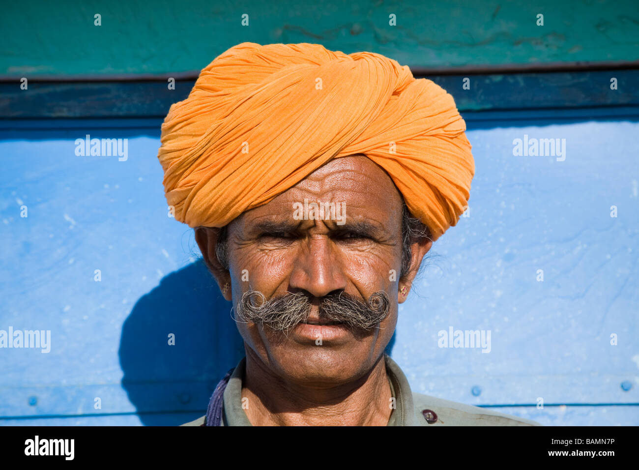 Man wearing a colourful saffron turban at Osian Camel Camp, Osian, Rajasthan, India Stock Photo