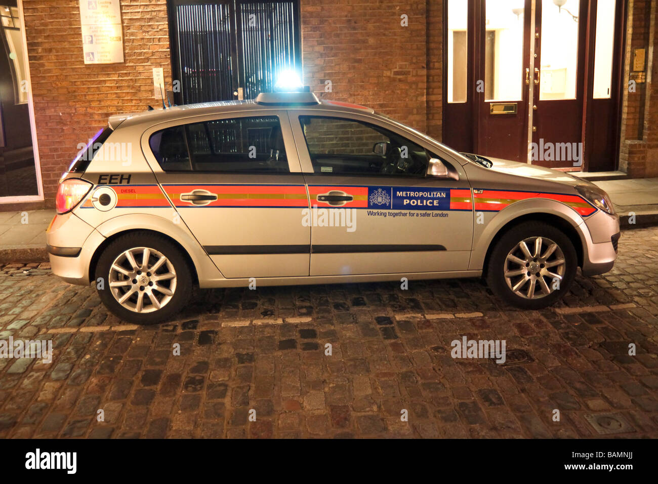 police car with emergency blue lights flashing, London, England Stock Photo