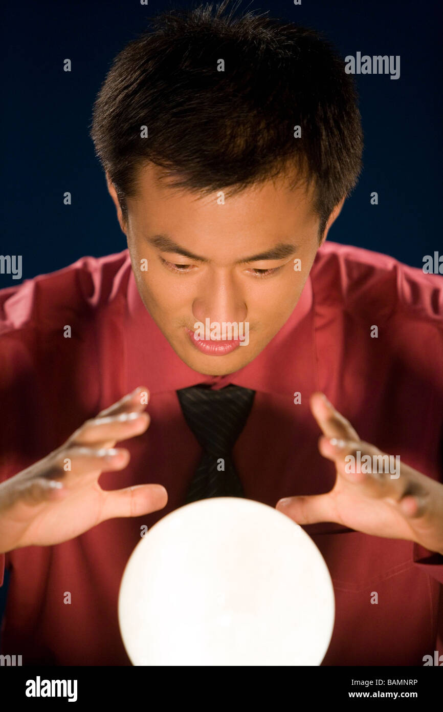 Businessman looking into crystal ball hires stock photography and images Alamy