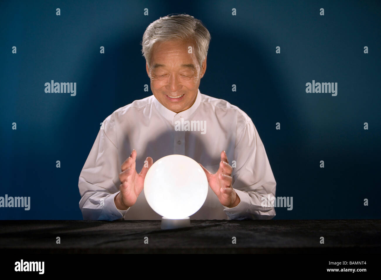 Older Businessman Looking Into Crystal Ball Stock Photo - Alamy