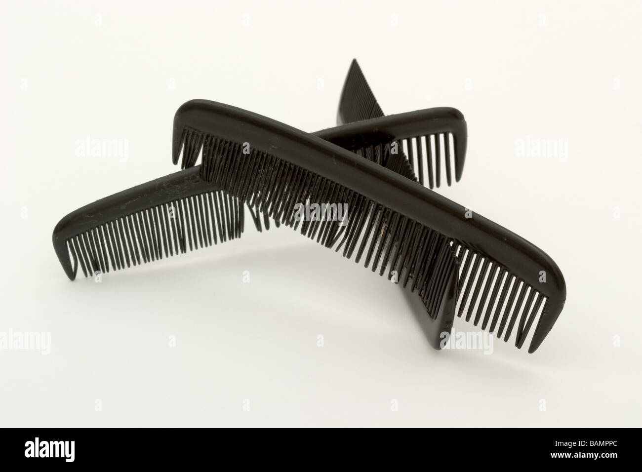Three black plastic combs intertwined with one another Stock Photo Alamy