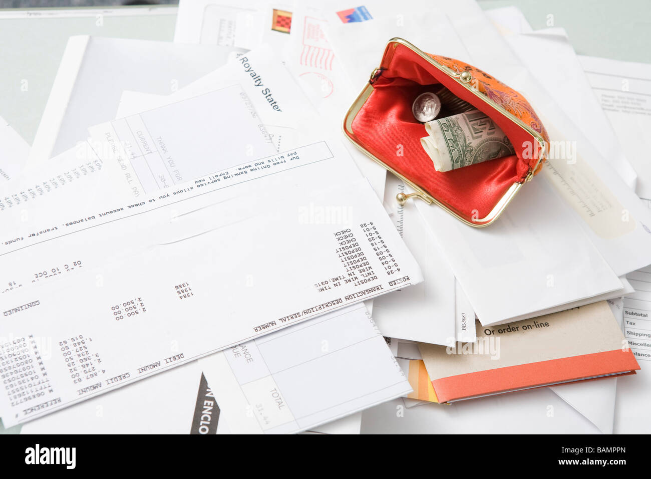 Open coin purse on pile of bills Stock Photo Alamy