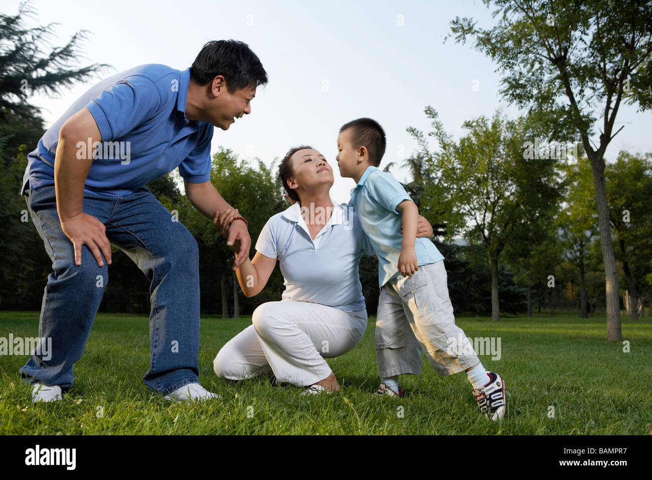 Family Playing Together In Park Stock Photo - Alamy