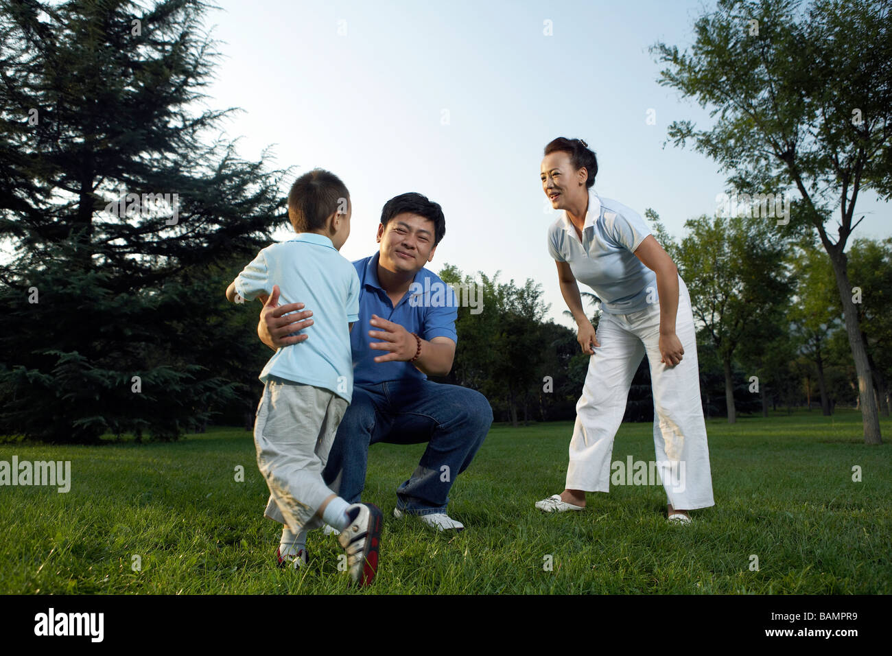 Family Playing Together In Park Stock Photo - Alamy