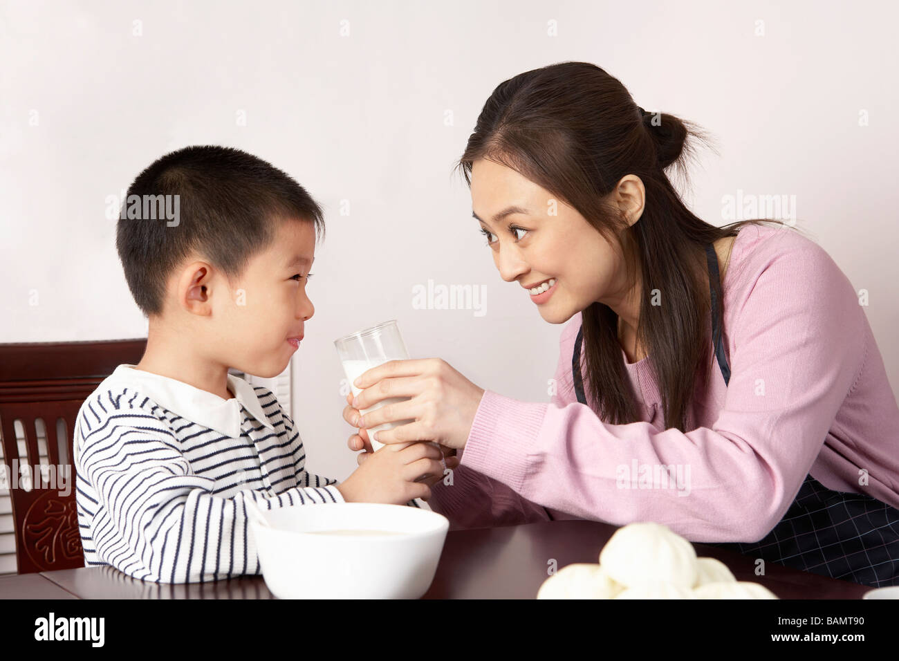 Mother Giving Son A Glass Of Milk Stock Photo - Alamy