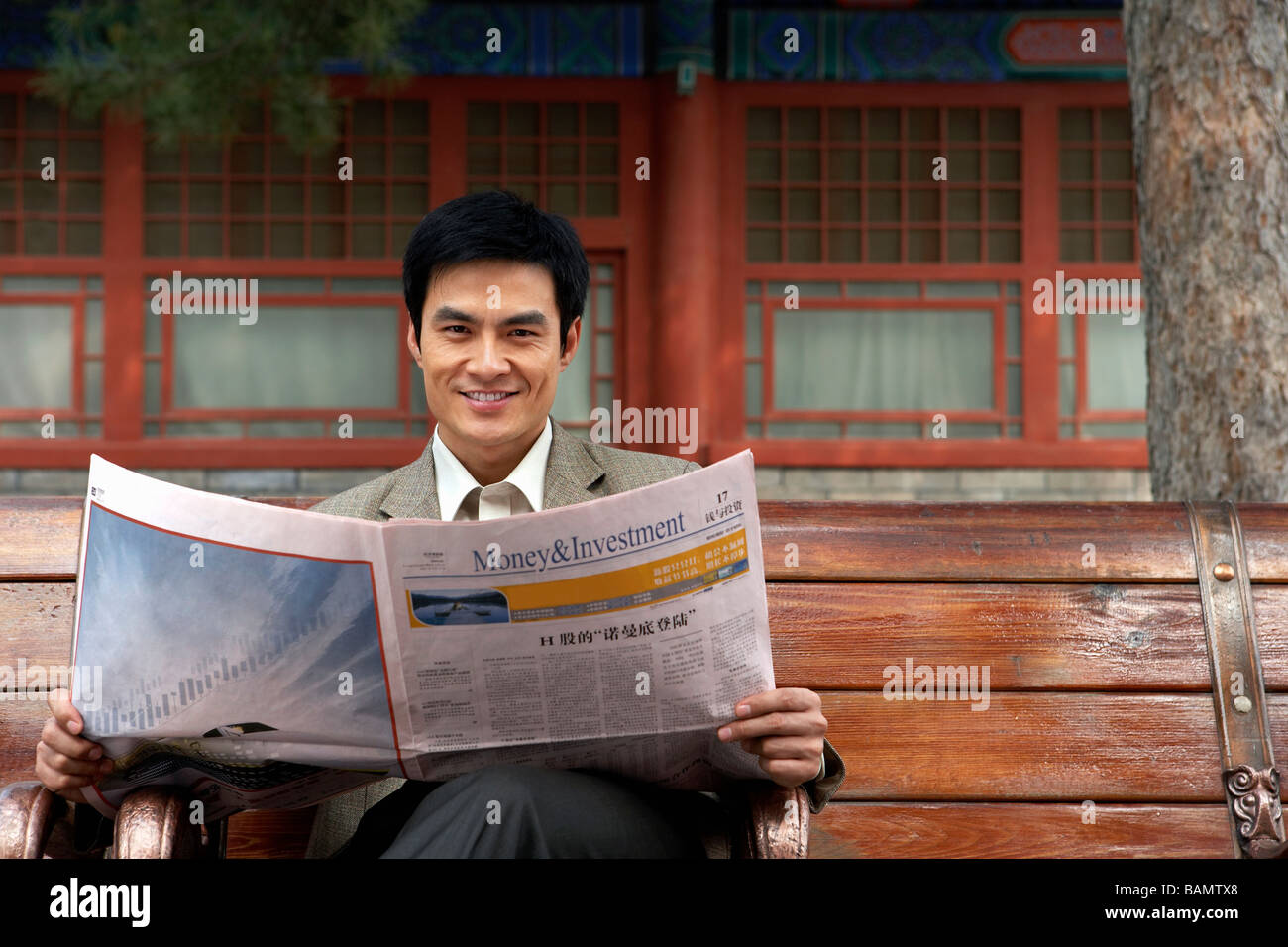 Businessman Sitting On A Park Bench Reading The Newspaper Stock Photo ...