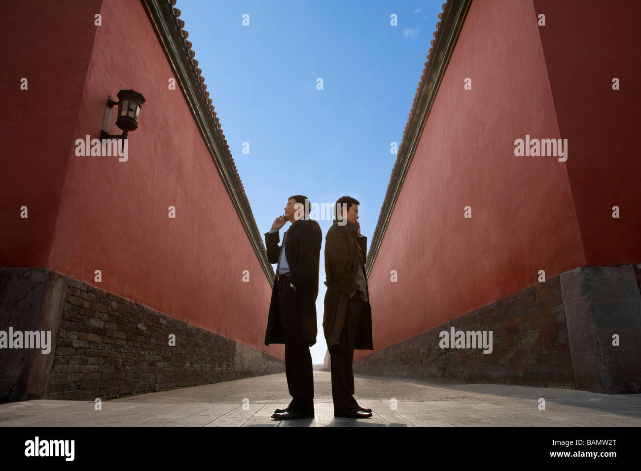 Businessmen Standing Back To Back Next To Building Stock Photo - Alamy