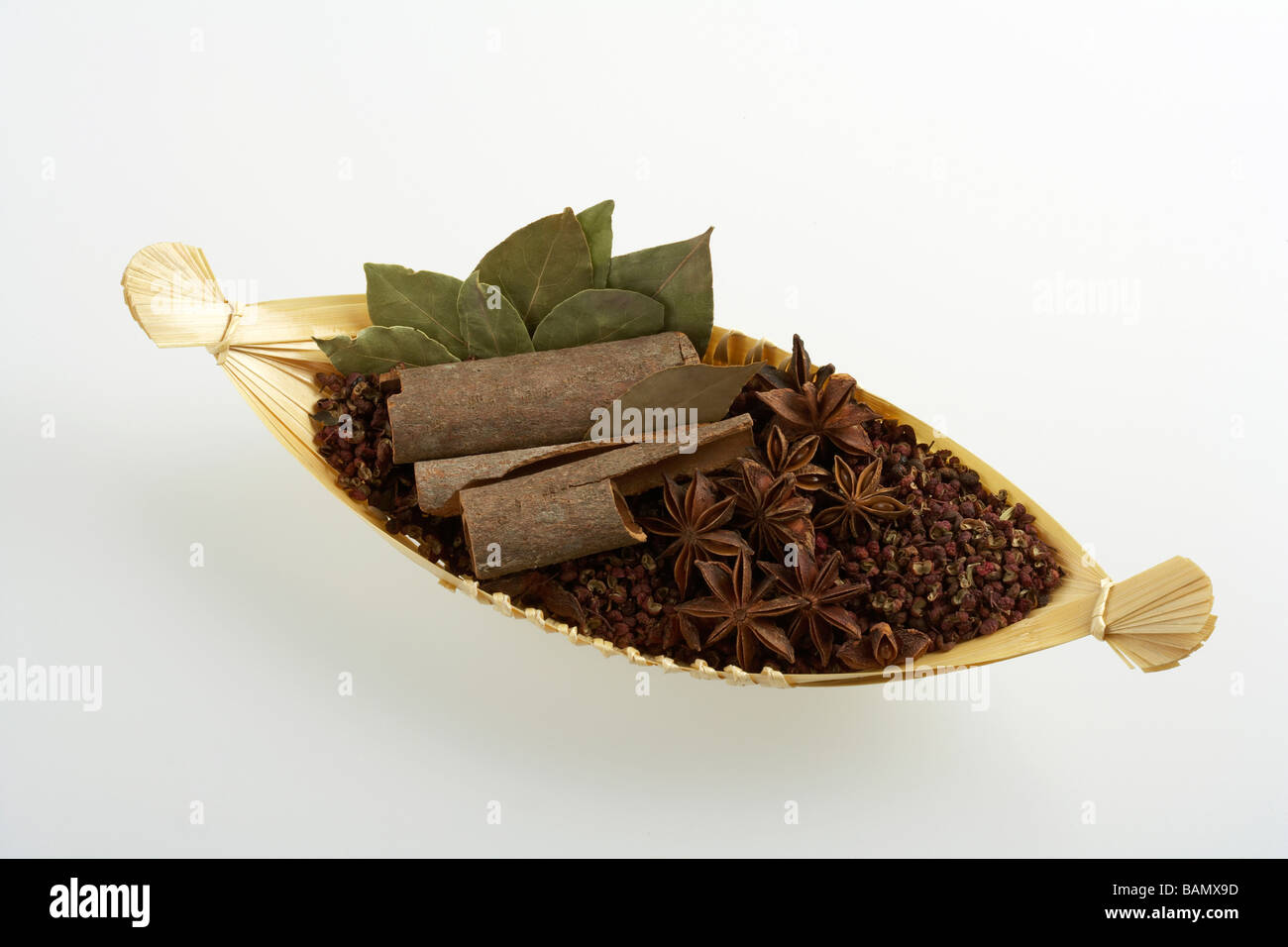 Star anise, cinnamon, spices and bay leaves in a woven basket Stock Photo Alamy
