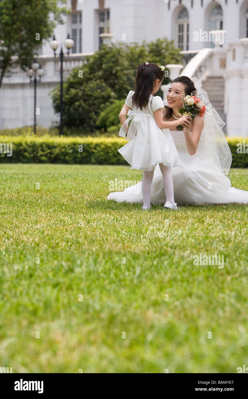 A young flower girl with the bride after a wedding Stock Photo
