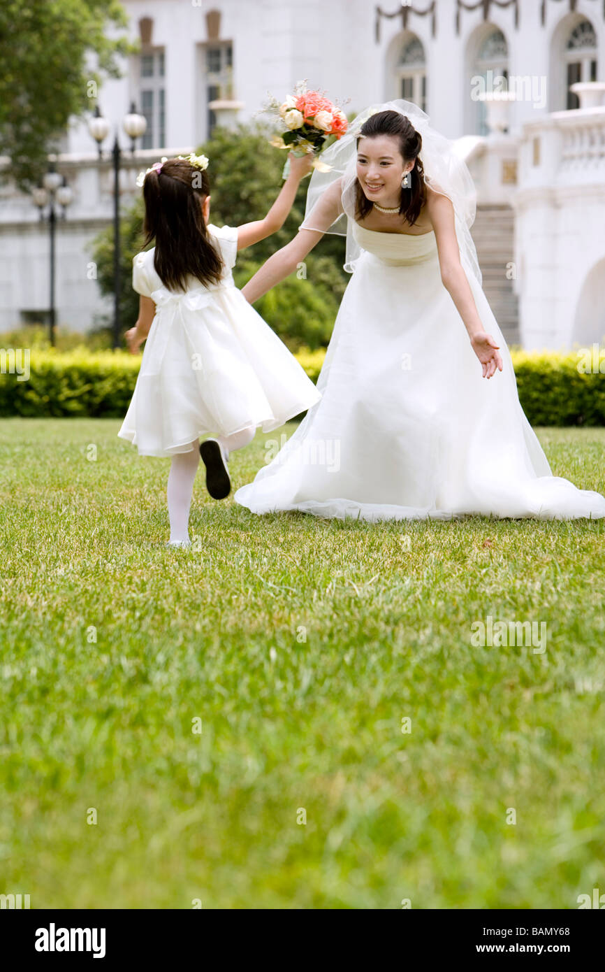 A young flower girl with the bride after a wedding Stock Photo