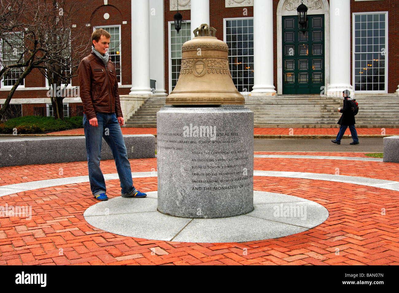 Male student looking at a replica of the Centennial Bell, Baker Library, Harvard Business School, Cambridge, Massachusetts, USA Stock Photo