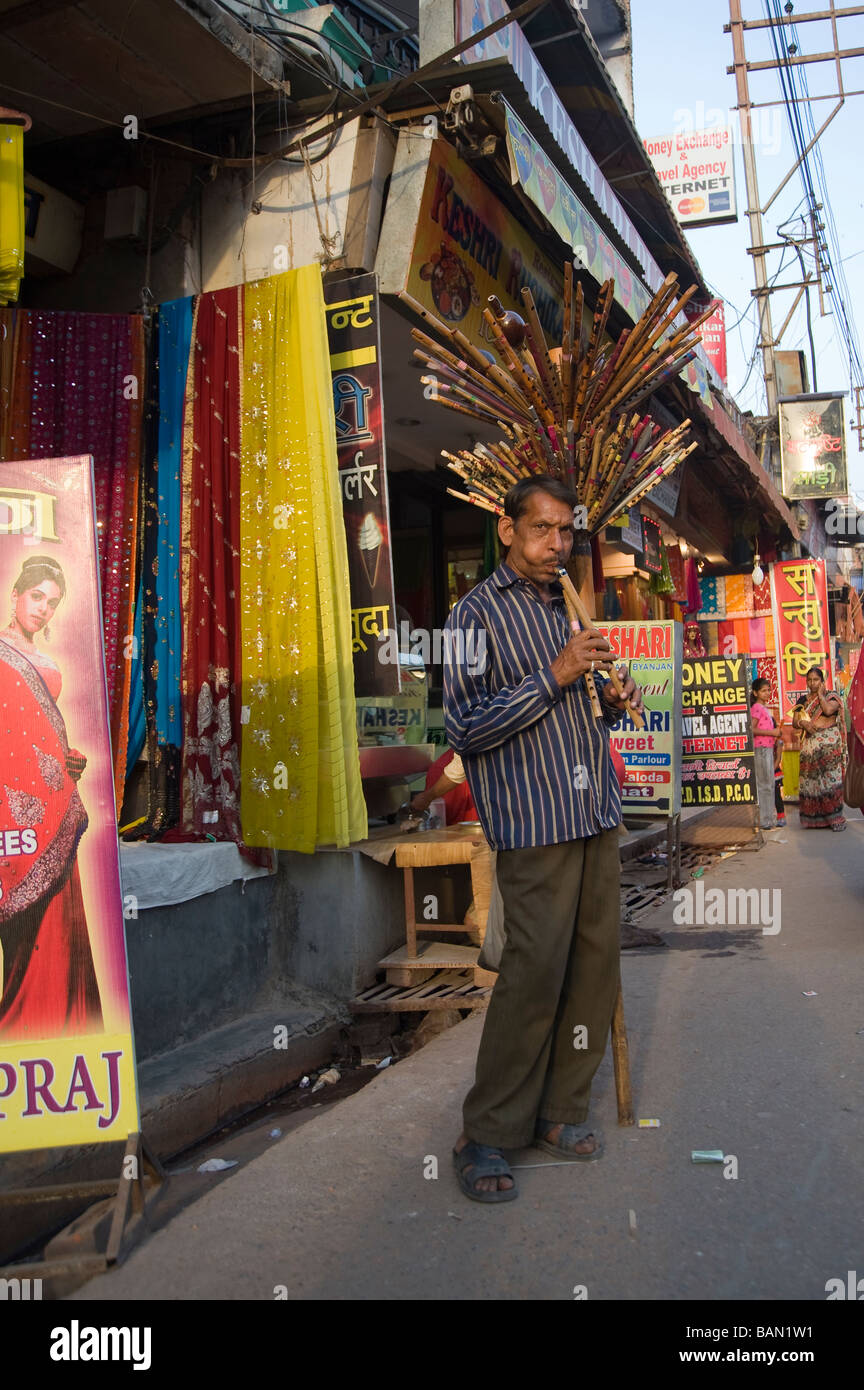 Indian man playing flute in the street of the old city of Varanasi Benares Uttar Pradesh India Stock Photo