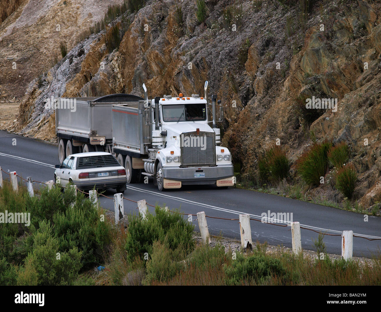 HEAVY GOODS TRACTOR UNIT VEHICLE CLIMBING HILL OUT OF QUEENSTOWN TASMANIA AUSTRALIA Stock Photo