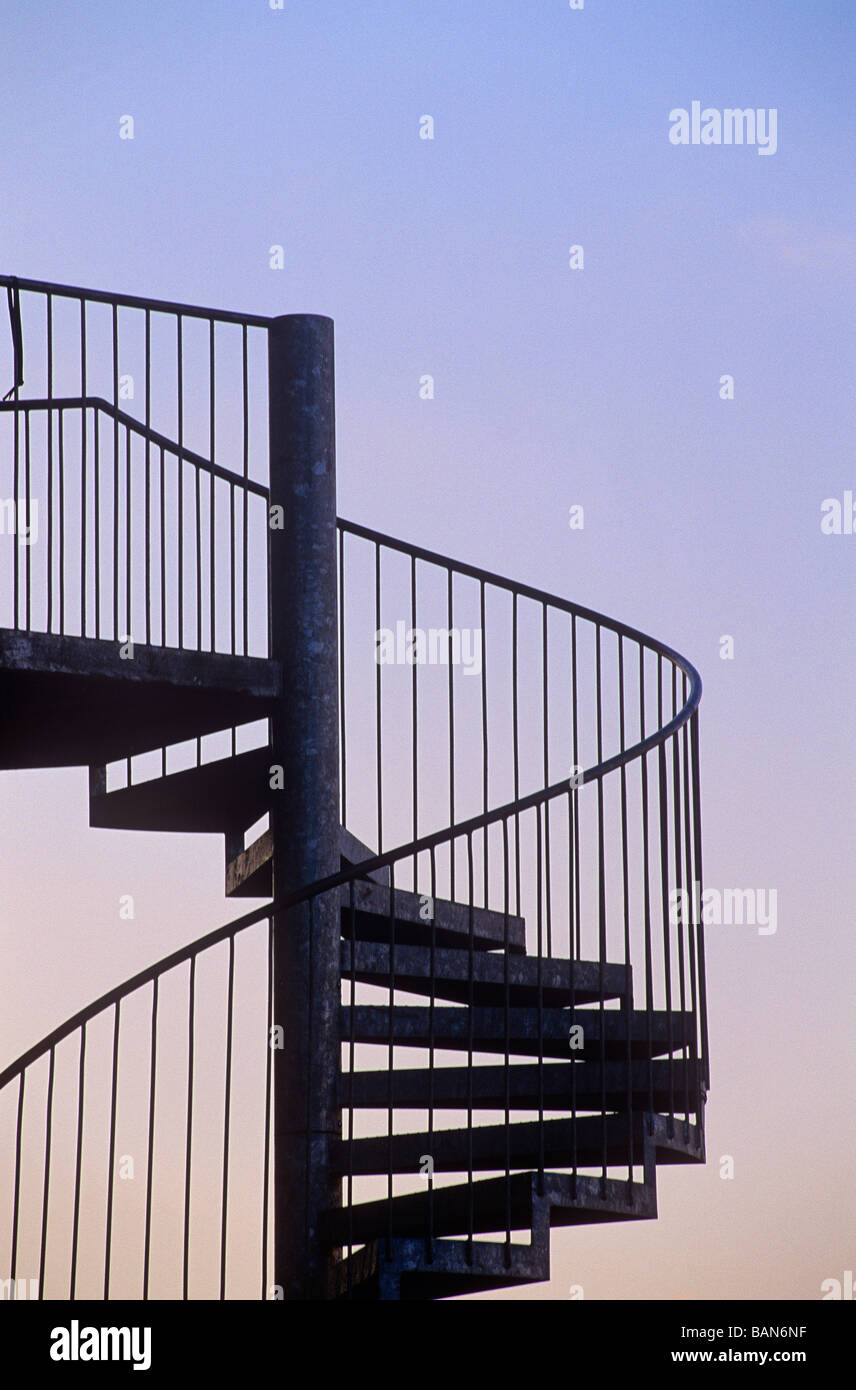 outdoor spiral steps and emergency stairs at evening Stock Photo