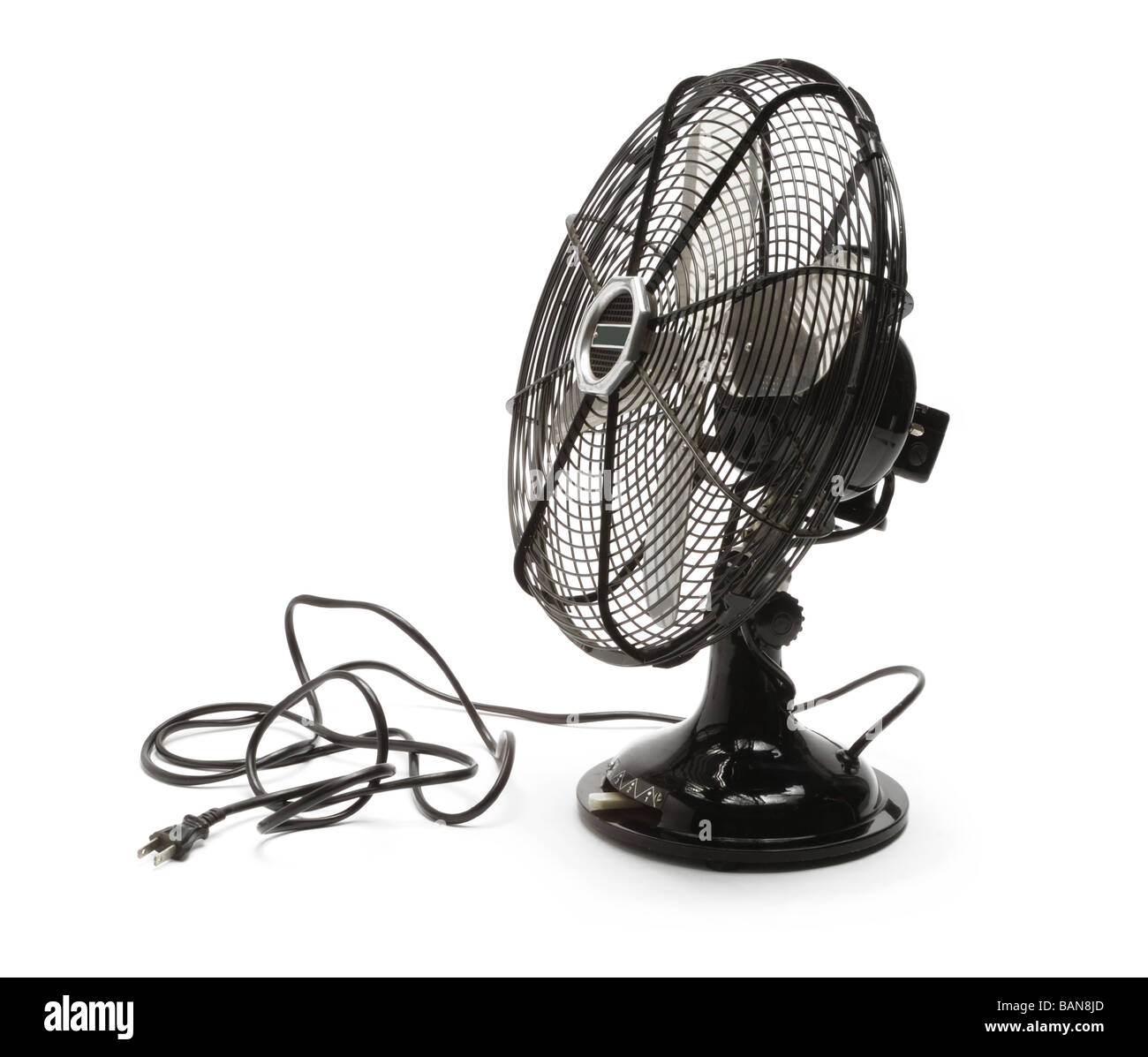 A metal desk fan with black cord and plug Stock Photo