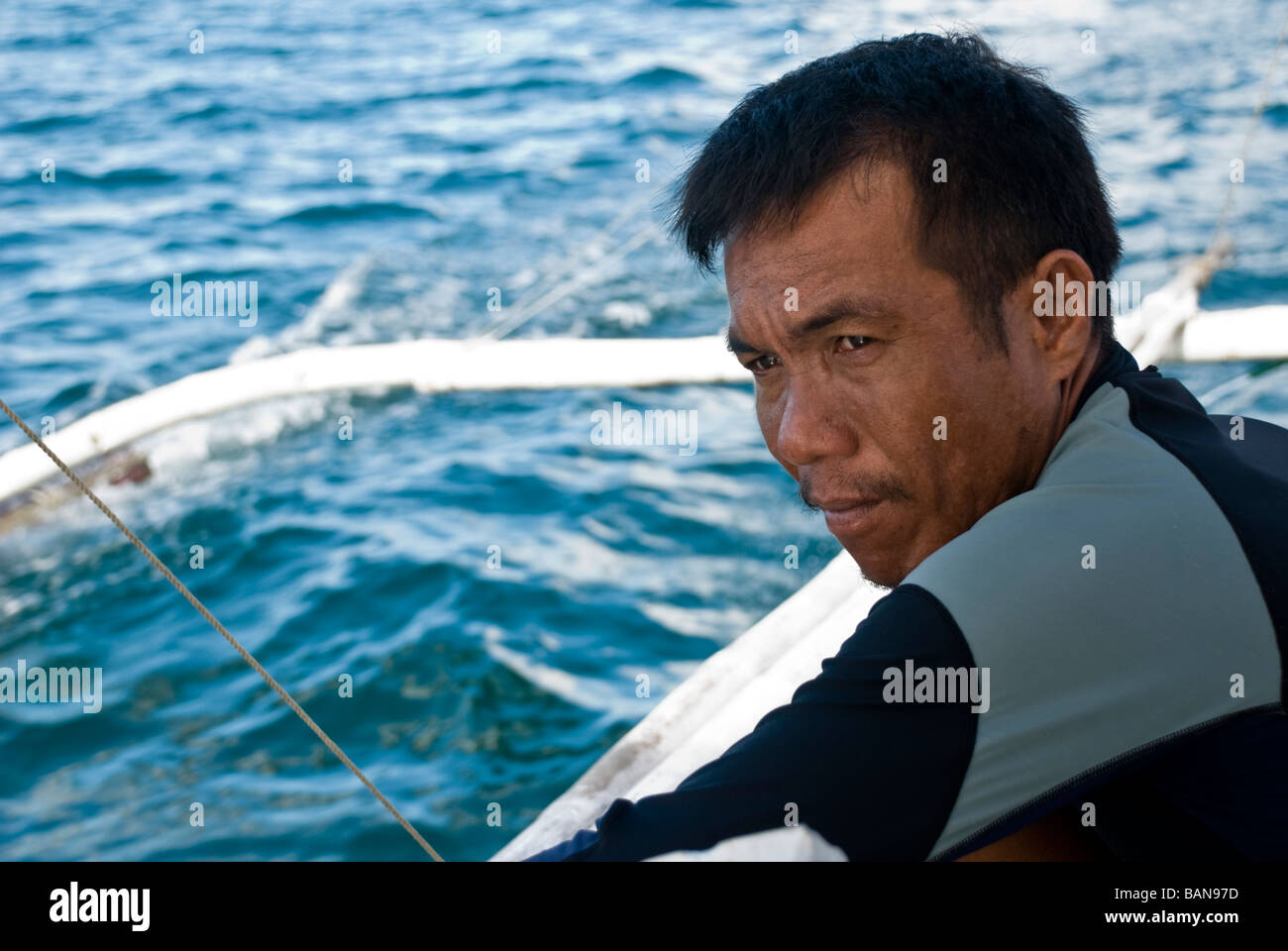 Butanding Interaction Officer watches the water on a whale shark spttiing trip in Donsol, Philippines Stock Photo