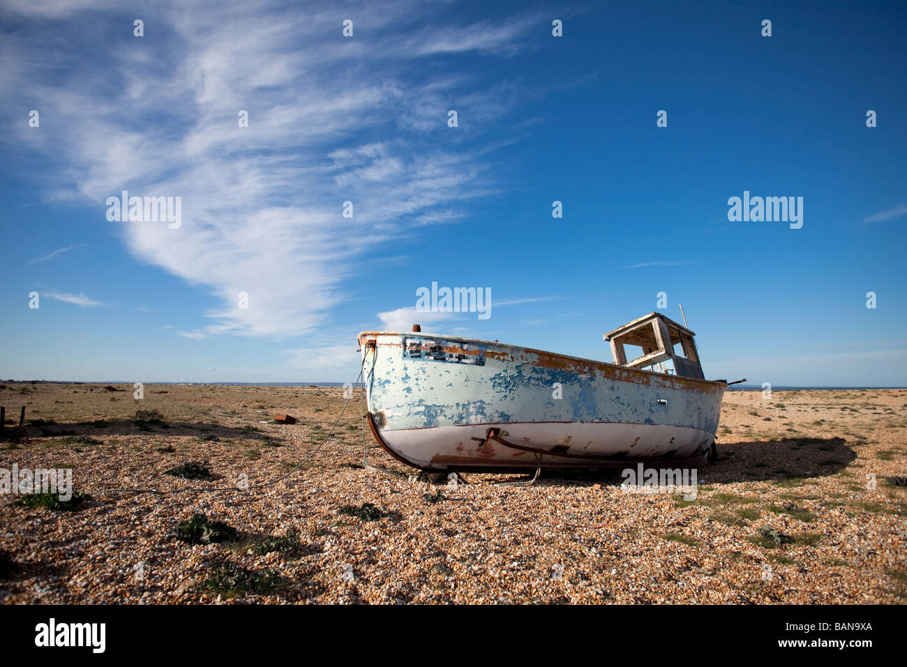 Abandoned fishing boat beached on the shingle of South East England ...