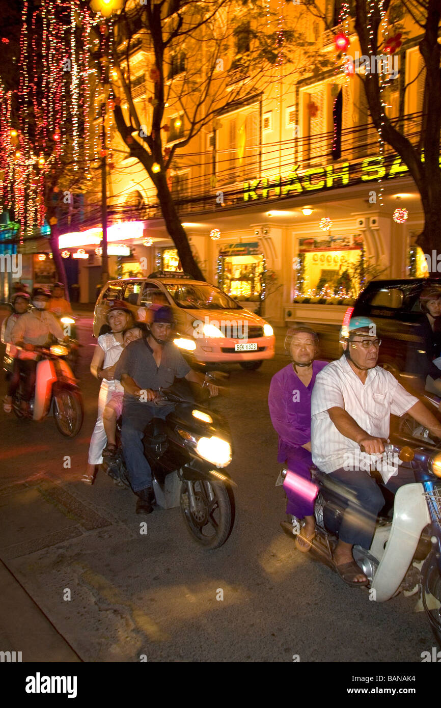 Vietnamese people ride motorbikes on Dong Khoi street the last night of