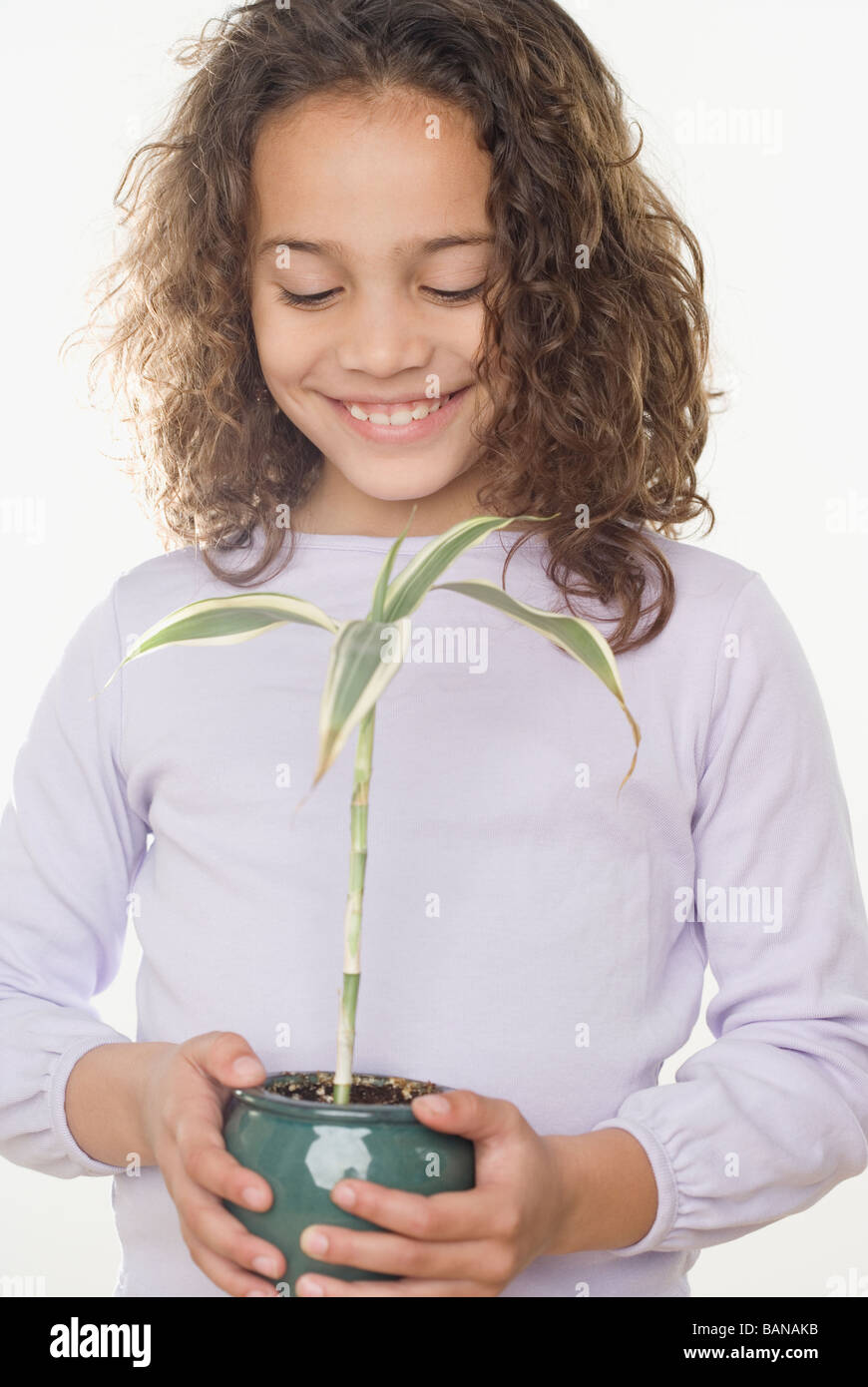 Young girl holding potted plant Stock Photo - Alamy