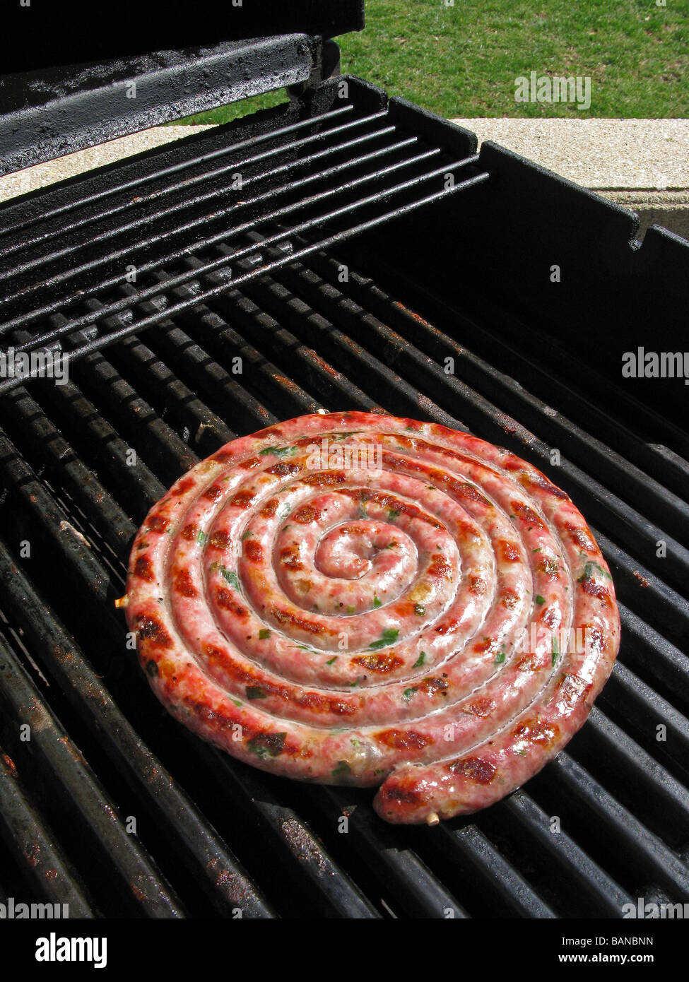 sausages grilling on an outdoor grill Stock Photo Alamy