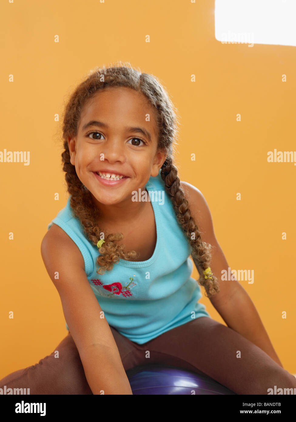African girl sitting on exercise ball Stock Photo Alamy
