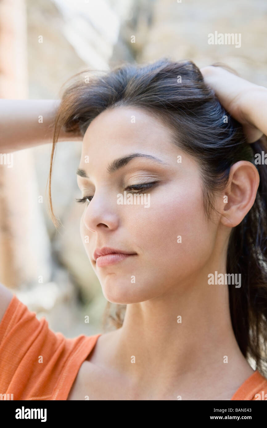 Hispanic woman lifting hair Stock Photo Alamy