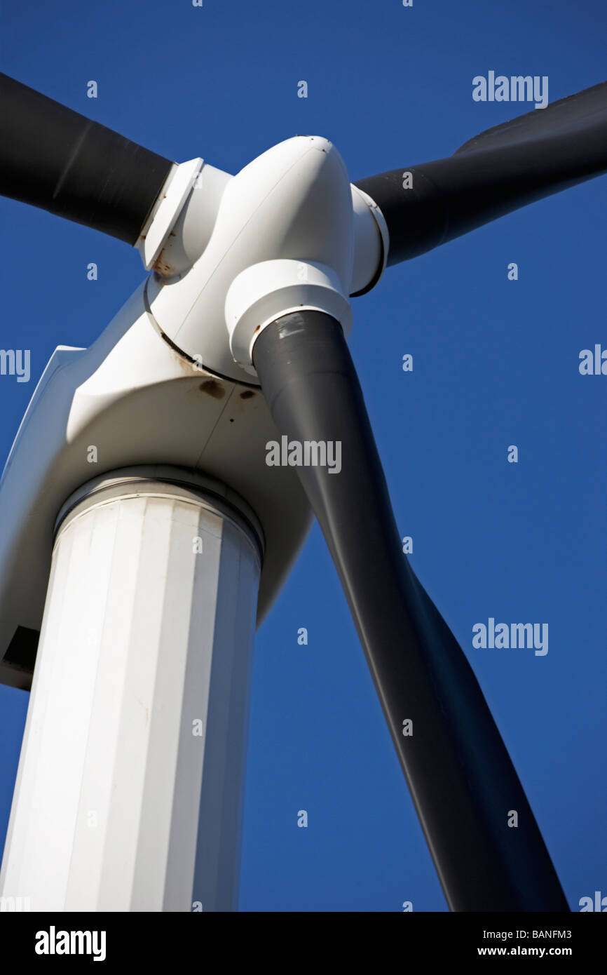 Closeup of a power generating windmill against a blue sky Stock Photo