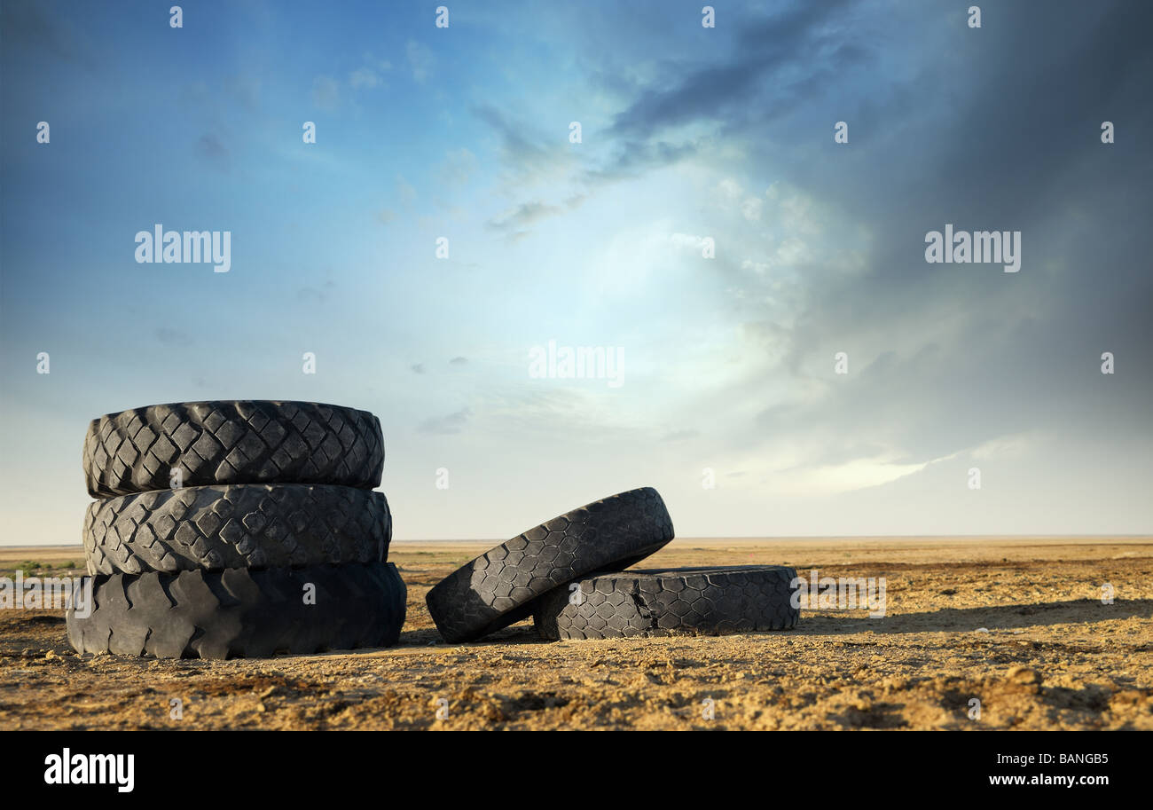 Five abandoned tires outdoors as a symbol of environmental pollution